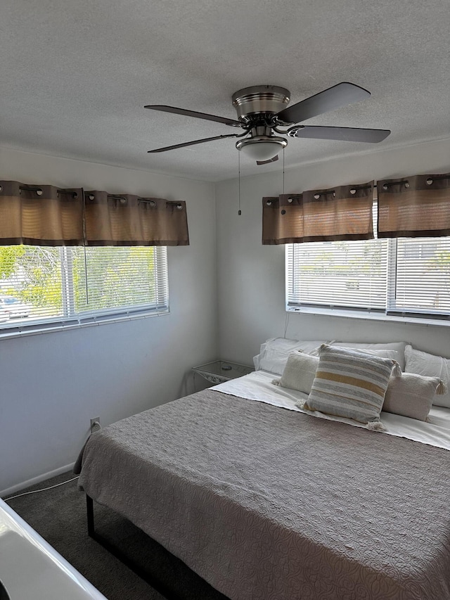 bedroom featuring a textured ceiling and a ceiling fan