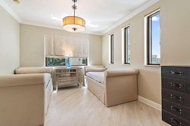 bedroom featuring multiple windows, ornamental molding, and light wood finished floors