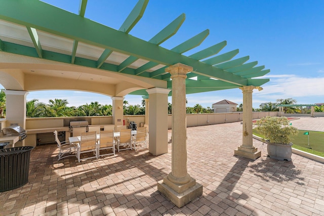 view of patio with area for grilling, outdoor dining area, and an outdoor kitchen