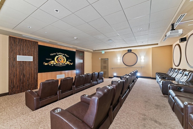 carpeted home theater featuring baseboards and a paneled ceiling