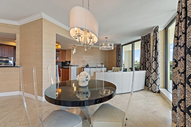 dining space with baseboards, a notable chandelier, and crown molding