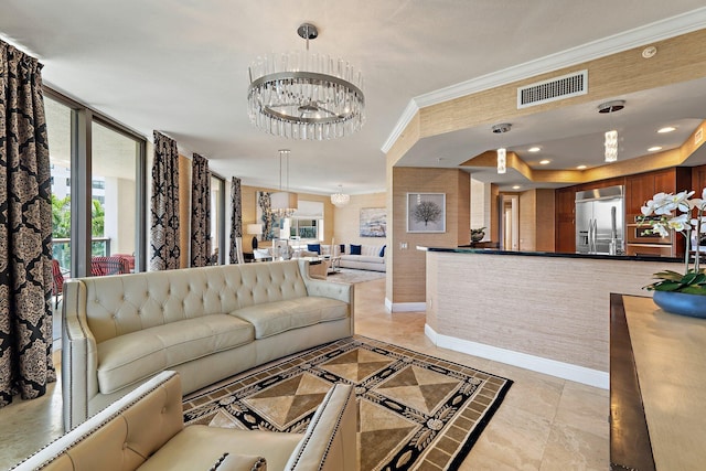 living room featuring an inviting chandelier, visible vents, baseboards, and ornamental molding
