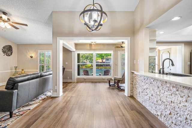648 Deer Creek Edgewater Dr, Deerfield Beach, FL 33442 - foyer featuring recessed lighting, ceiling fan with notable chandelier, wood finished floors, and a wealth of natural light
