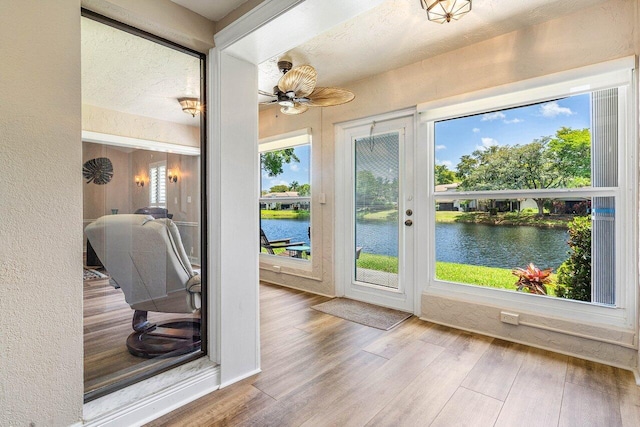 648 Deer Creek Edgewater Dr, Deerfield Beach, FL 33442 - entryway with a water view, a textured wall, a ceiling fan, and wood finished floors