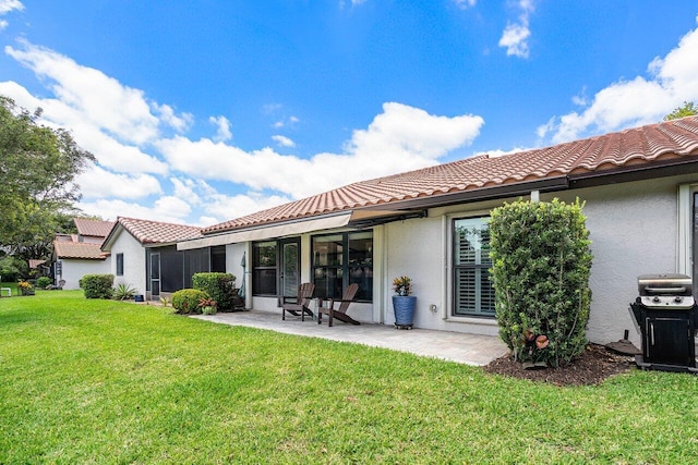 648 Deer Creek Edgewater Dr, Deerfield Beach, FL 33442 - rear view of property with a lawn, stucco siding, a tile roof, and a patio