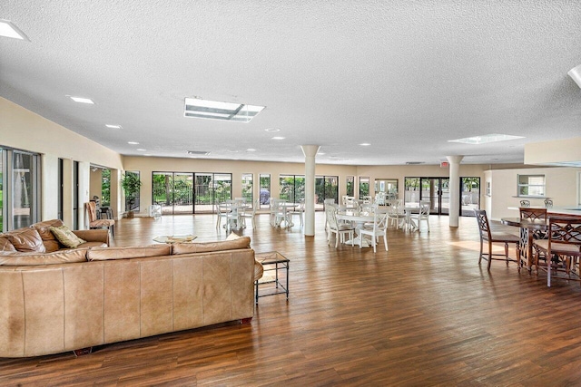 648 Deer Creek Edgewater Dr, Deerfield Beach, FL 33442 - living room featuring decorative columns, recessed lighting, a textured ceiling, and wood finished floors