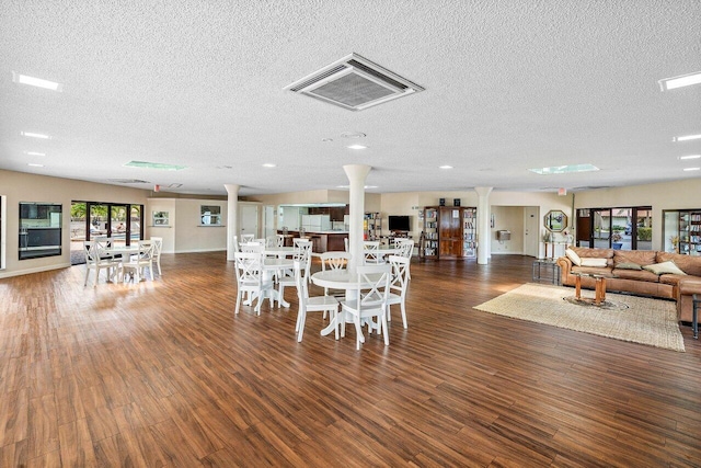 648 Deer Creek Edgewater Dr, Deerfield Beach, FL 33442 - dining area featuring ornate columns, a textured ceiling, wood finished floors, and visible vents