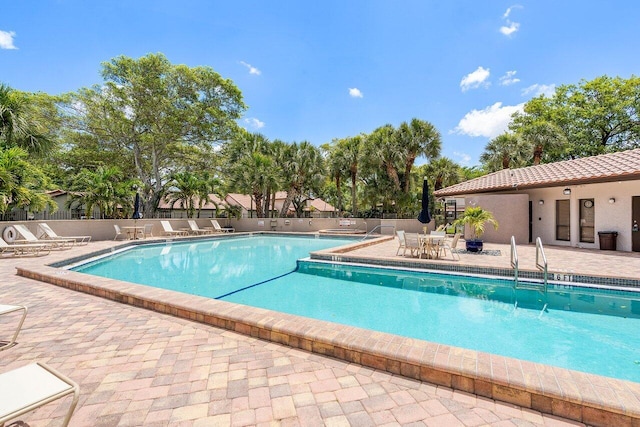 648 Deer Creek Edgewater Dr, Deerfield Beach, FL 33442 - community pool with fence and a patio