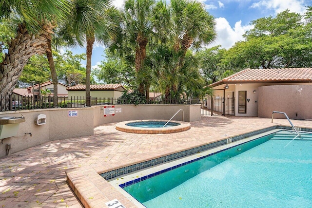 648 Deer Creek Edgewater Dr, Deerfield Beach, FL 33442 - community pool featuring a community hot tub, a patio area, and fence