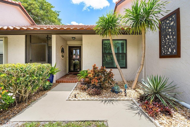 648 Deer Creek Edgewater Dr, Deerfield Beach, FL 33442 - entrance to property with a tiled roof and stucco siding