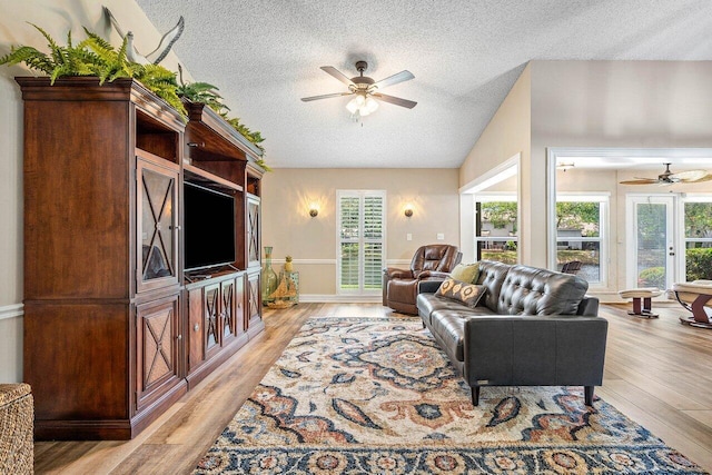 648 Deer Creek Edgewater Dr, Deerfield Beach, FL 33442 - living room with plenty of natural light, ceiling fan, light wood finished floors, and a textured ceiling