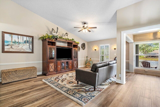 648 Deer Creek Edgewater Dr, Deerfield Beach, FL 33442 - living room with a textured ceiling, ceiling fan, wood finished floors, and vaulted ceiling