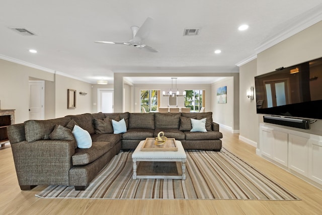 living area featuring crown molding, light wood finished floors, a chandelier, recessed lighting, and a ceiling fan