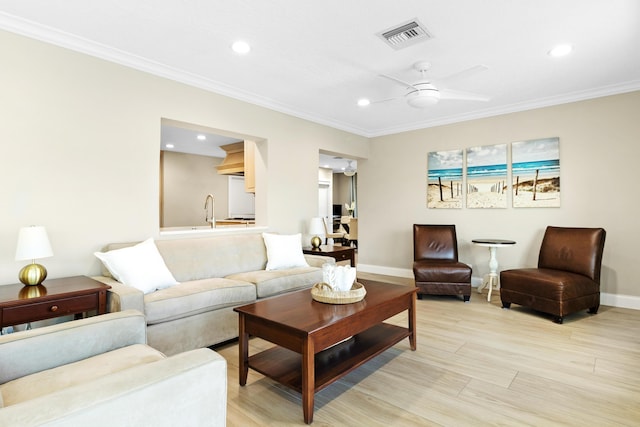 living area with ornamental molding, baseboards, recessed lighting, a ceiling fan, and light wood-type flooring