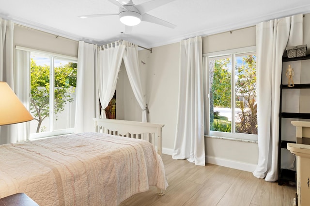 2320 SE 8th Ct, Pompano Beach, FL 33062 - bedroom featuring baseboards, multiple windows, ceiling fan, and wood finished floors