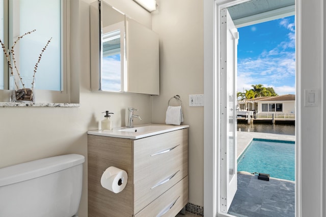 bathroom with vanity, toilet, and a water view