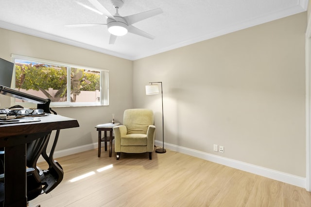 sitting room with light wood finished floors, an office area, baseboards, and ceiling fan