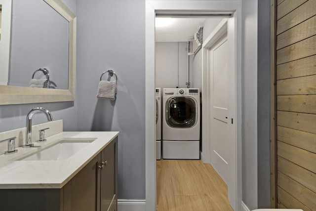 laundry room featuring washing machine and dryer and light wood-type flooring