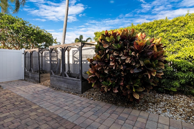 view of patio featuring fence and exterior structure