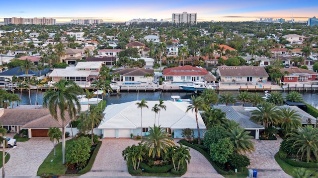 aerial view at dusk of a view of city, a water view, and a residential view