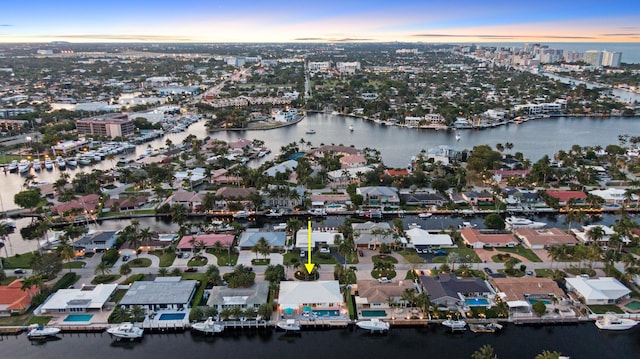 view of property location with a nearby body of water and nearby urban area