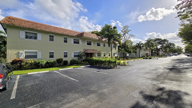 view of building exterior with uncovered parking