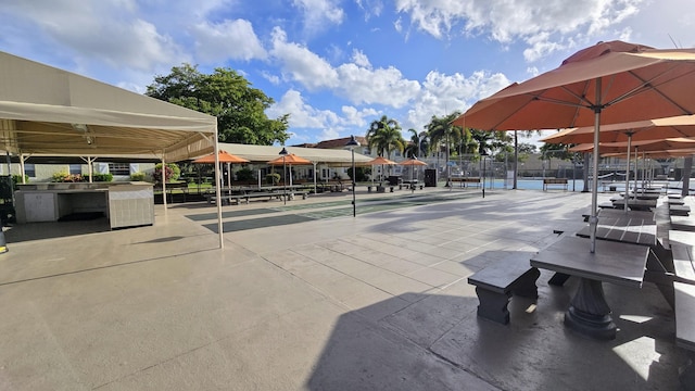 surrounding community with shuffleboard and fence