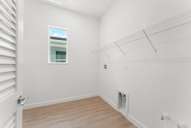 10241 SW Carnelian St, Port Saint Lucie, FL 34987 - laundry room with gas dryer hookup, laundry area, baseboards, light wood finished floors, and hookup for a washing machine