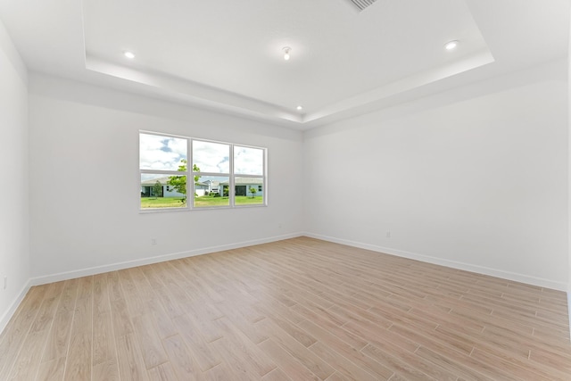10241 SW Carnelian St, Port Saint Lucie, FL 34987 - empty room with recessed lighting, light wood-style flooring, and a tray ceiling