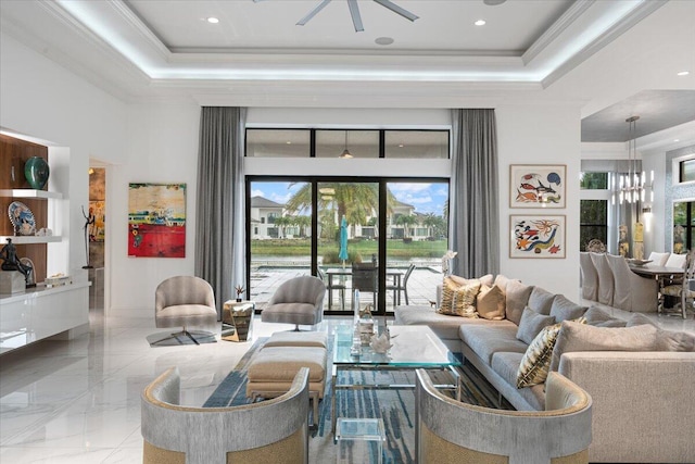 6940 NW 25th Way, Boca Raton, FL 33496 - living area with a tray ceiling, healthy amount of natural light, crown molding, a ceiling fan, and a chandelier