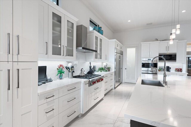 6940 NW 25th Way, Boca Raton, FL 33496 - kitchen featuring wall chimney exhaust hood, built in appliances, crown molding, backsplash, and a sink