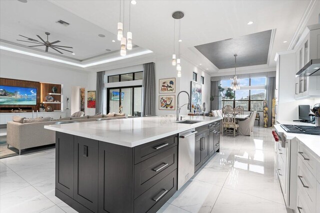 6940 NW 25th Way, Boca Raton, FL 33496 - kitchen featuring a tray ceiling, a sink, gas stove, dishwasher, and light marble finish flooring