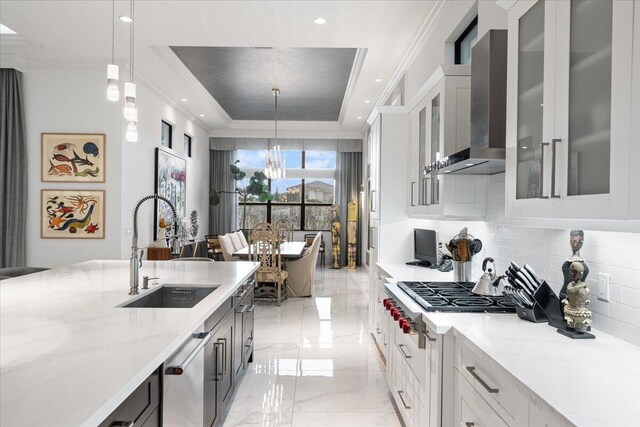 6940 NW 25th Way, Boca Raton, FL 33496 - kitchen with a raised ceiling, a sink, wall chimney range hood, a chandelier, and appliances with stainless steel finishes