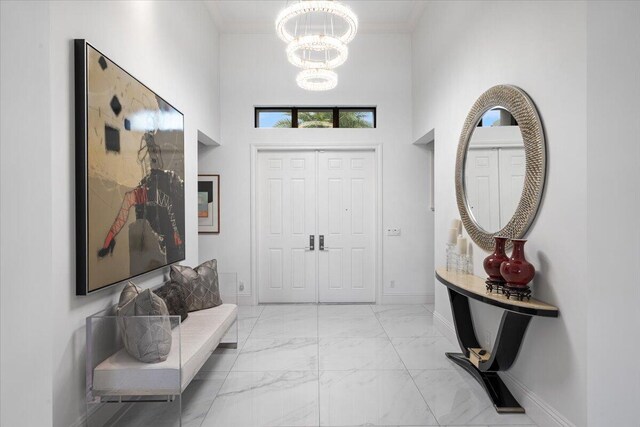 6940 NW 25th Way, Boca Raton, FL 33496 - entrance foyer with a chandelier, light marble finish floors, a towering ceiling, ornamental molding, and baseboards
