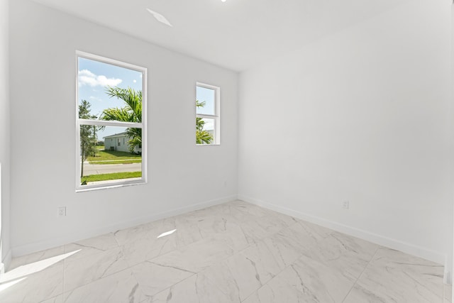 10128 SW Carnelian St, Port Saint Lucie, FL 34987 - spare room featuring baseboards and marble finish floor