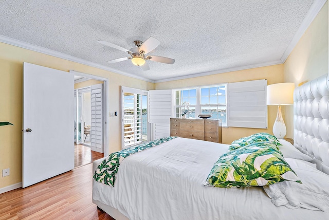 bedroom with ornamental molding, a textured ceiling, and wood finished floors