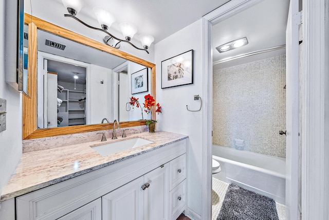 bathroom featuring shower / bath combination, toilet, visible vents, tile patterned floors, and vanity