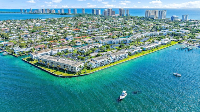 birds eye view of property with a water view and a city view