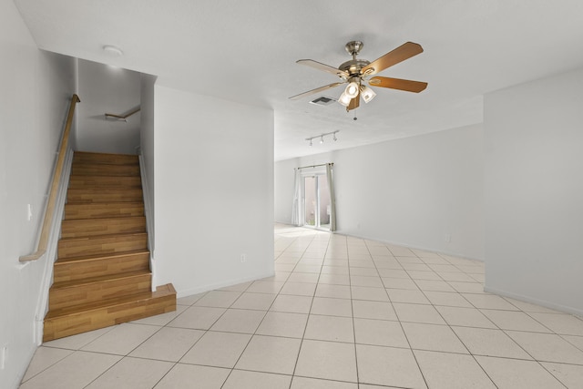 10531 NW 57th St, Coral Springs, FL 33076 - spare room with a ceiling fan, stairway, rail lighting, and baseboards