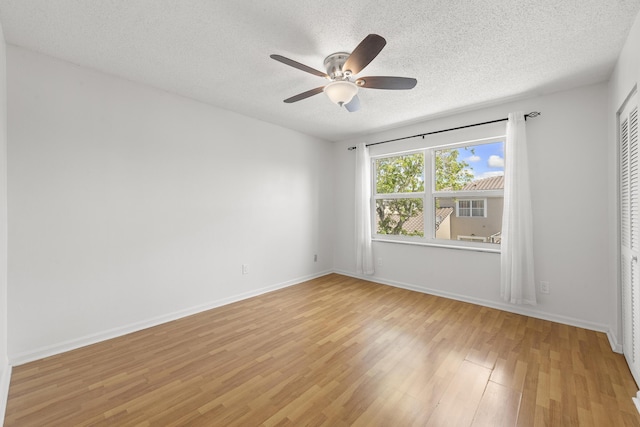 10531 NW 57th St, Coral Springs, FL 33076 - empty room featuring a textured ceiling, light wood-type flooring, ceiling fan, and baseboards