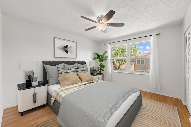 10531 NW 57th St, Coral Springs, FL 33076 - bedroom with a textured ceiling, light wood-type flooring, ceiling fan, and baseboards