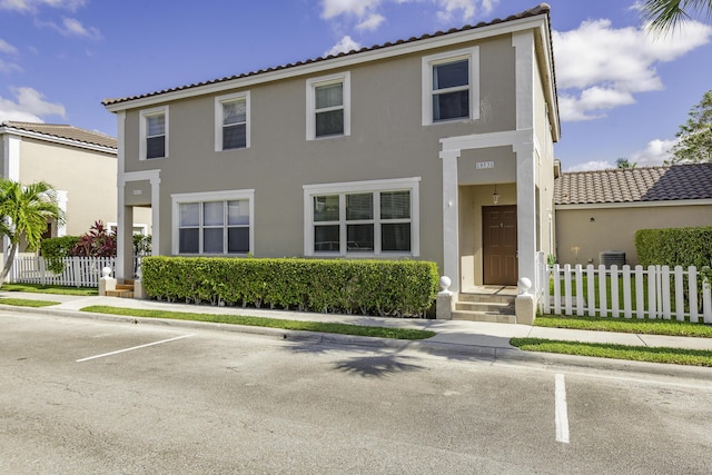 10531 NW 57th St, Coral Springs, FL 33076 - townhome / multi-family property with fence, stucco siding, uncovered parking, cooling unit, and a tiled roof