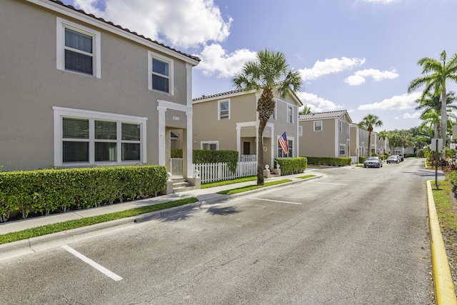 10531 NW 57th St, Coral Springs, FL 33076 - view of asphalt road with sidewalks, curbs, a residential view, and traffic signs