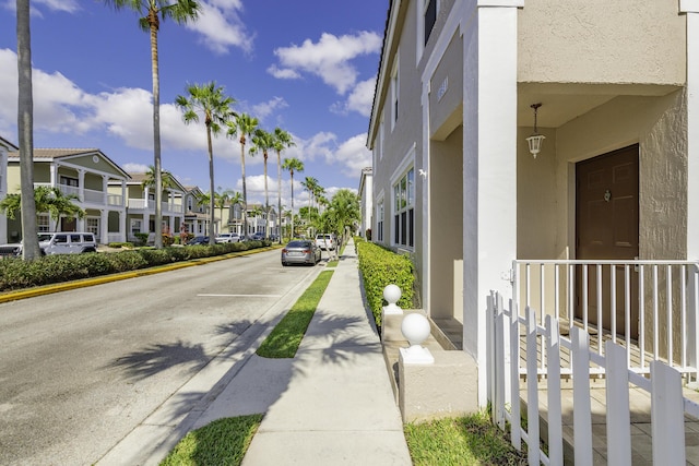 10531 NW 57th St, Coral Springs, FL 33076 - view of asphalt road featuring curbs, a residential view, sidewalks, and street lights