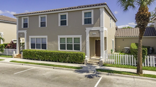 10531 NW 57th St, Coral Springs, FL 33076 - view of property featuring a tile roof, fence, and uncovered parking