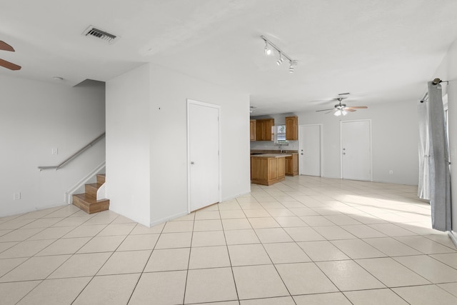 10531 NW 57th St, Coral Springs, FL 33076 - unfurnished living room featuring ceiling fan and stairway