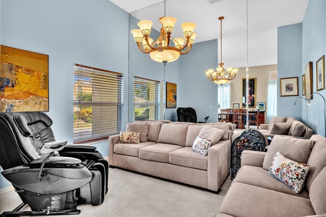 living room featuring light tile patterned floors, a high ceiling, and a chandelier