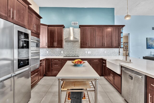kitchen with light countertops, light tile patterned flooring, a textured ceiling, and a sink