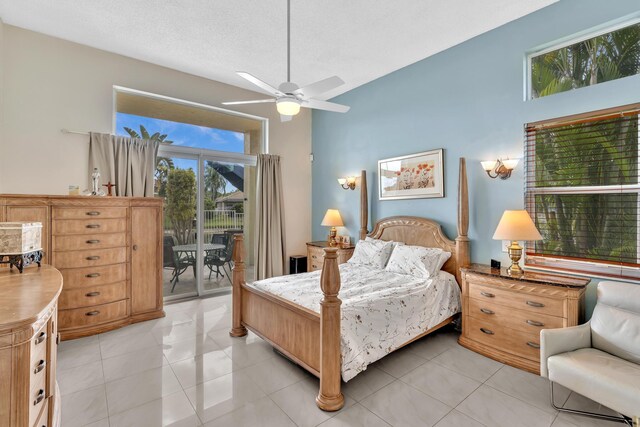 bedroom with ceiling fan, light tile patterned flooring, and access to exterior