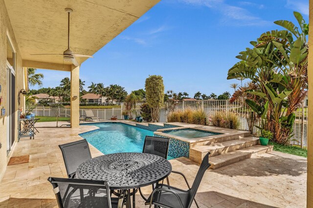 view of patio / terrace featuring a fenced backyard and a pool with connected hot tub
